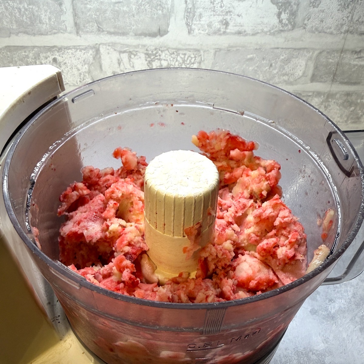 Chopped strawberries and banana in a food processor.