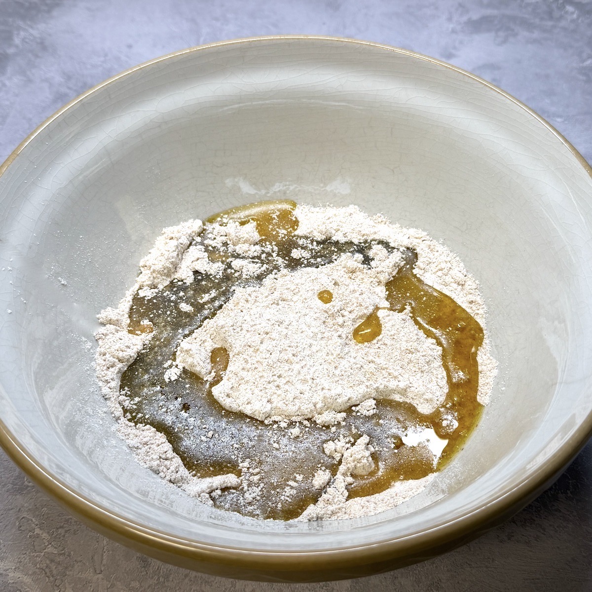 Flour and olive oil in a bowl.